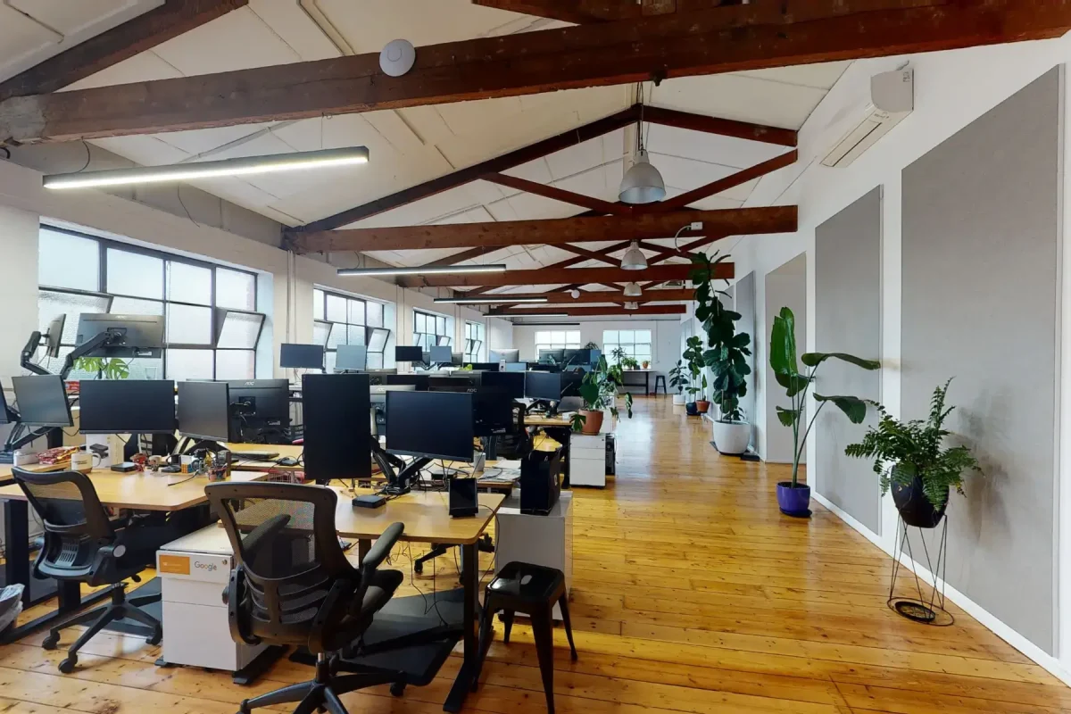 an office with a lot of desks and computers